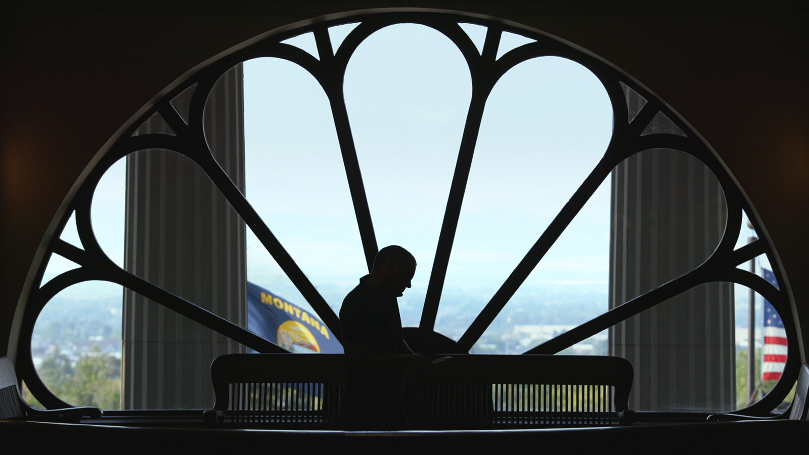 John S. Adams silhouetted in the Montana State Capitol building — still from DARK MONEY